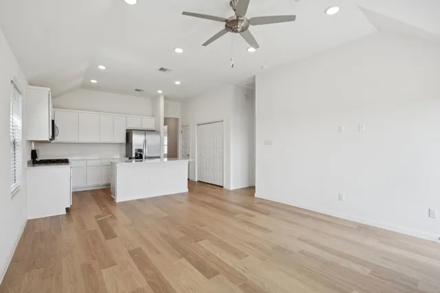 a view of kitchen with refrigerator microwave and white stove