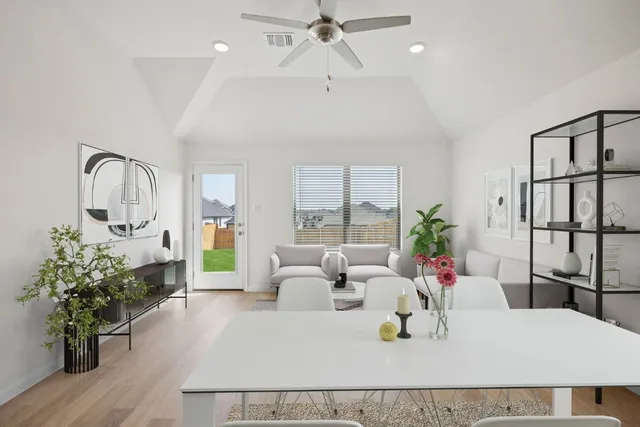 a living room with a large window and furniture