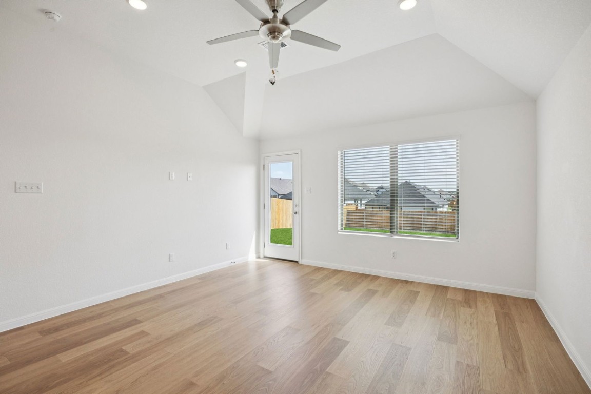 332 Bendecido Loop Elgin, TX 78621 - Photo 15 of 33 wooden floor in an empty room with a window