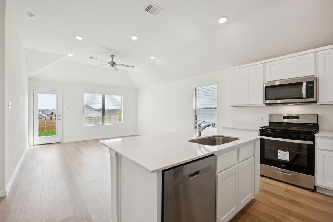332 Bendecido Loop Elgin, TX 78621 - Photo 8 of 33 a kitchen with sink stove and microwave