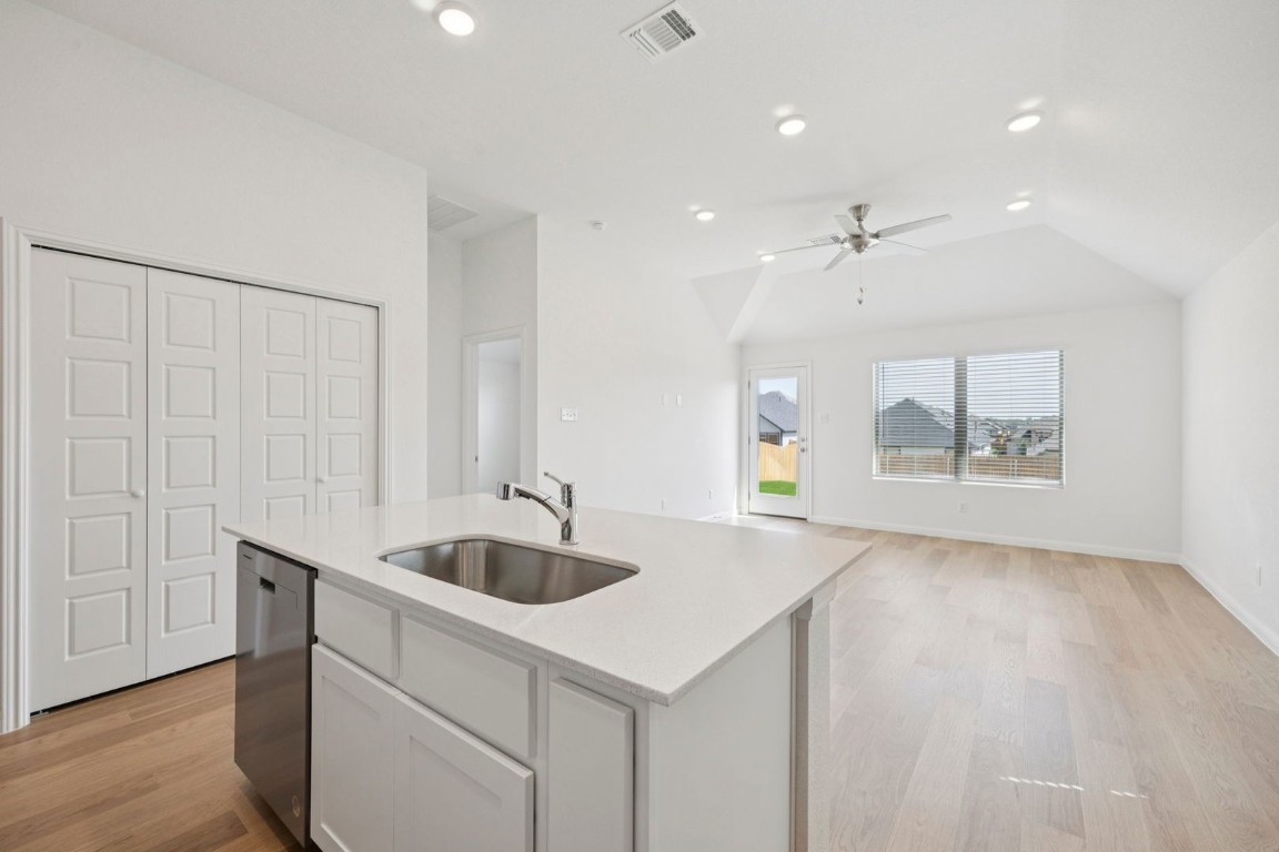 332 Bendecido Loop Elgin, TX 78621 - Photo 9 of 33 a kitchen with a sink and chandelier