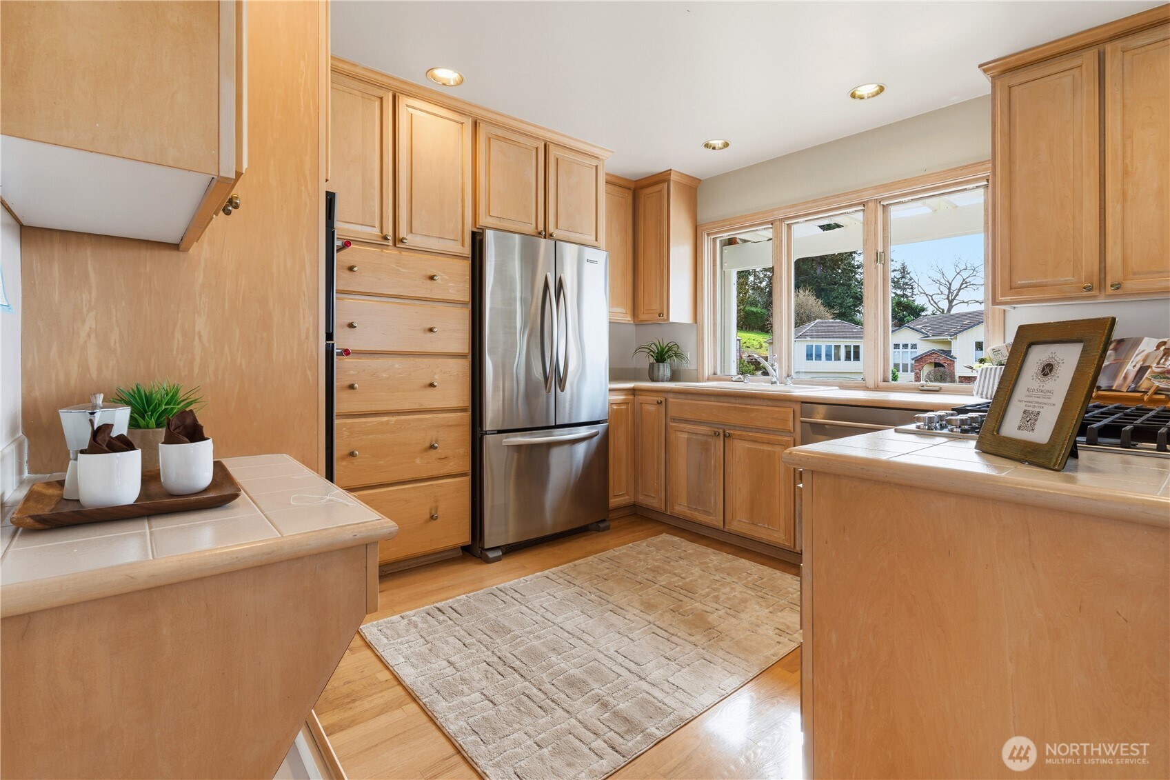 2626 Northwest 204th Street Shoreline, WA 98177 - Photo 11 of 35 a kitchen with sink a refrigerator and cabinets