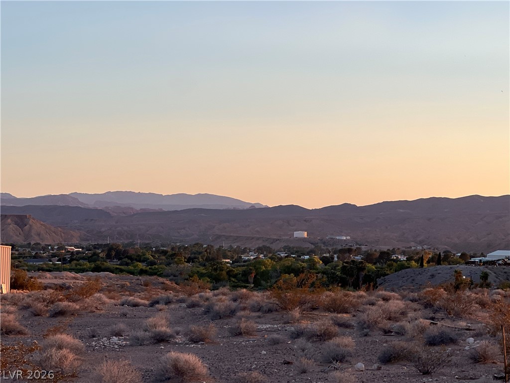 North Ishimoto Overton, NV 89040 - Photo 10 of 10 The captivating mountain range vista at dusk, stretching across a scenic rural landscape.