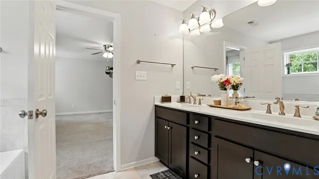 a view of a patio with table and chairs potted plants and a large tree