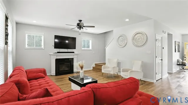 a living room with furniture a fireplace and a flat screen tv