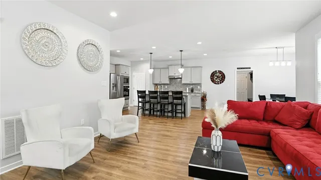 a living room with furniture and flat screen tv