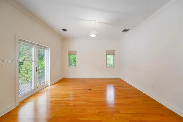 wooden floor in an empty room with a window