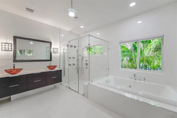 a bathroom with a granite countertop toilet a sink and bathtub