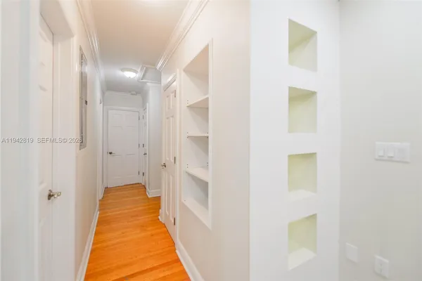 a view of a room with wooden floor and fan