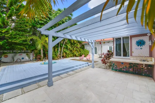 a front view of a house with a yard and tree s