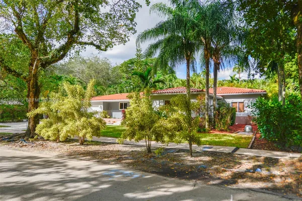 a front view of house with yard and outdoor seating