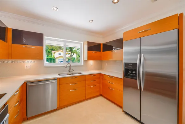 a kitchen with stainless steel appliances a stove a sink and a microwave
