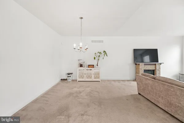 a living room with furniture chandelier and window