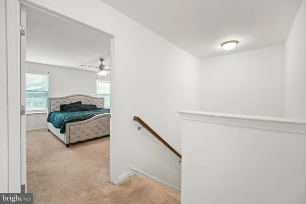 a bedroom with a bed dresser and a window