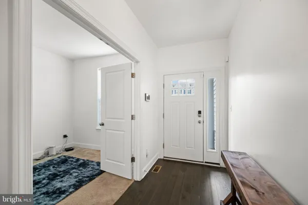a view of room with hardwood floor and hallway