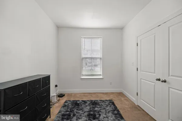 a view of a utility room with window closet and wooden floor