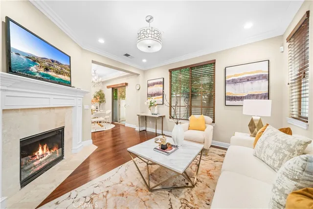 a living room with furniture a fireplace and a large window