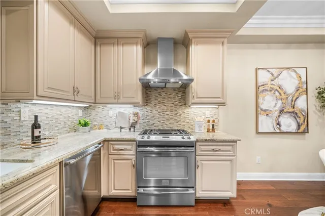 a kitchen with a stove a sink and chandelier