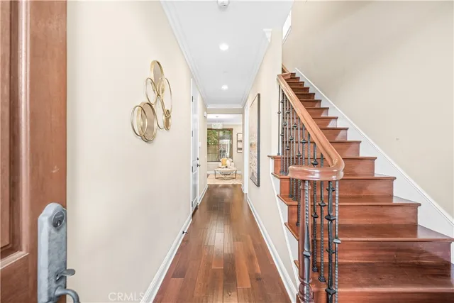 a view of an entryway with wooden floor and stairs