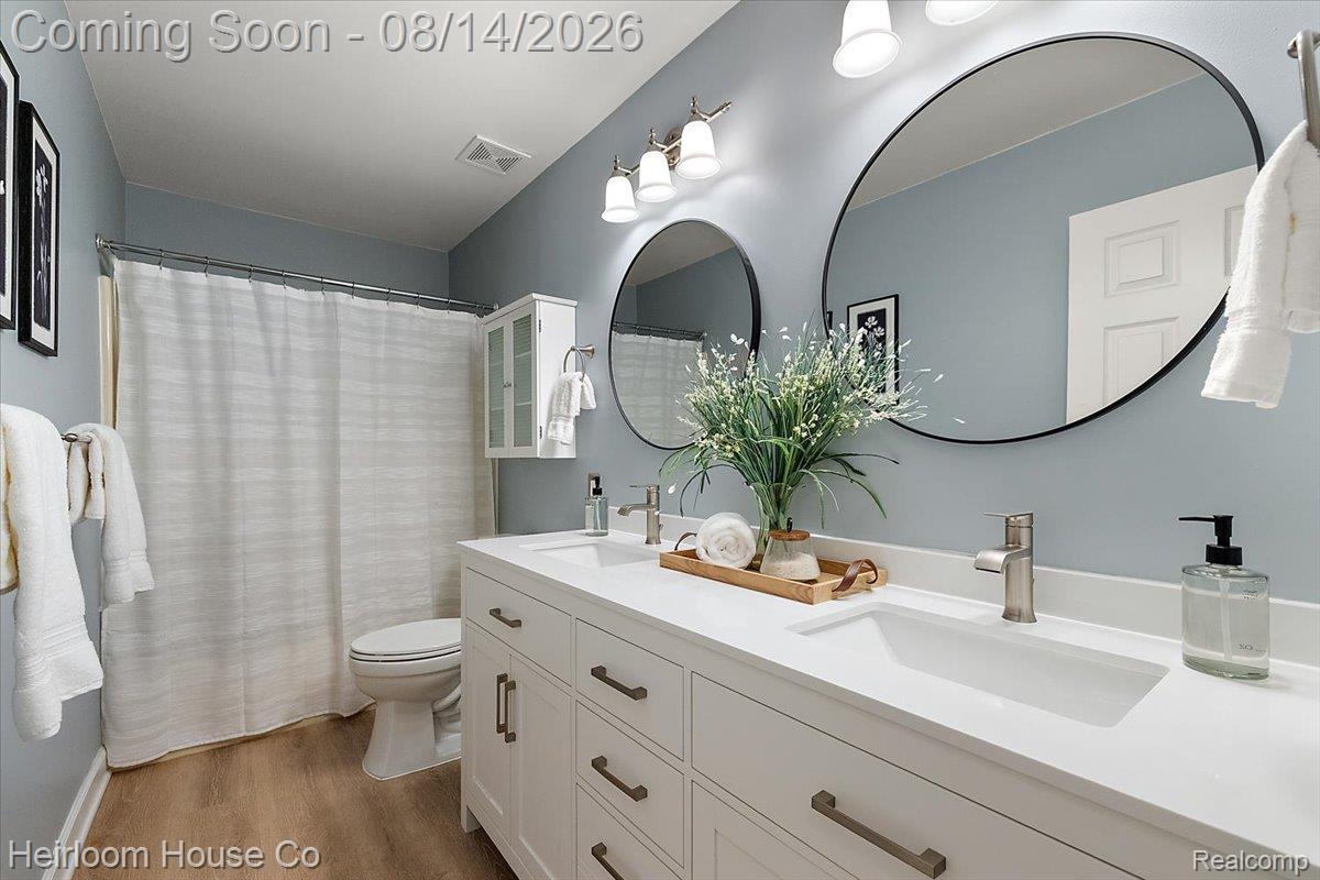 45697 Bryn Mawr Road Canton, MI 48187 - Photo 19 of 75 Bathroom featuring a dual-sink vanity with white cabinetry, integrated sinks, and brushed nickel hardware