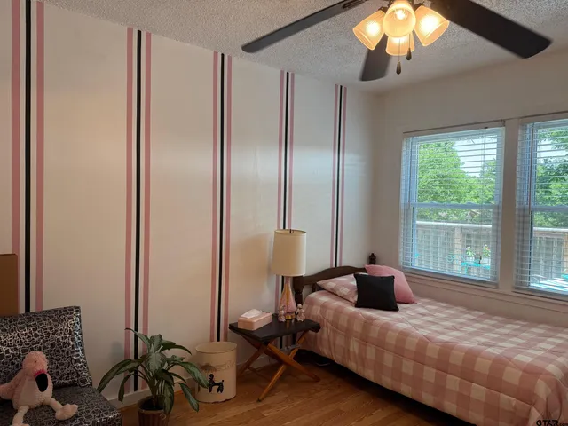 a bedroom with a bed and a chandelier