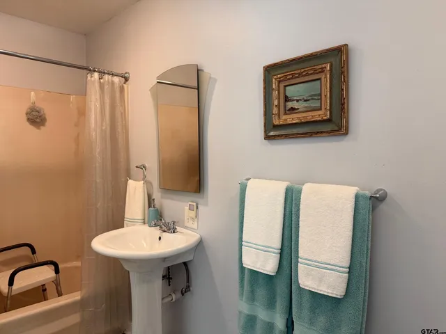 a bathroom with a toilet a sink and a mirror