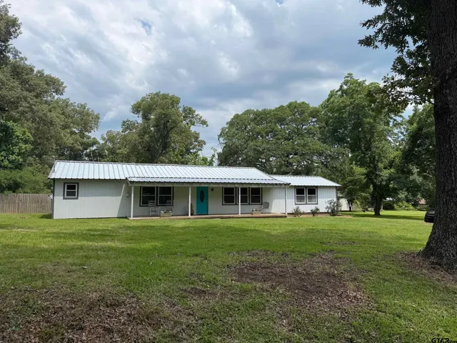 a view of house with yard and green space