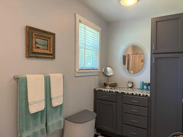 a bathroom with a sink toilet and mirror