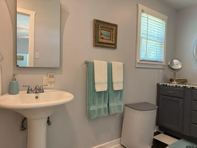 a kitchen with stainless steel appliances granite countertop a stove top oven a sink a dining table and chairs with wooden floor