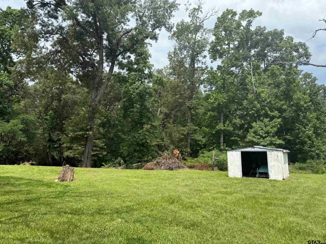a backyard of a house with lots of green space