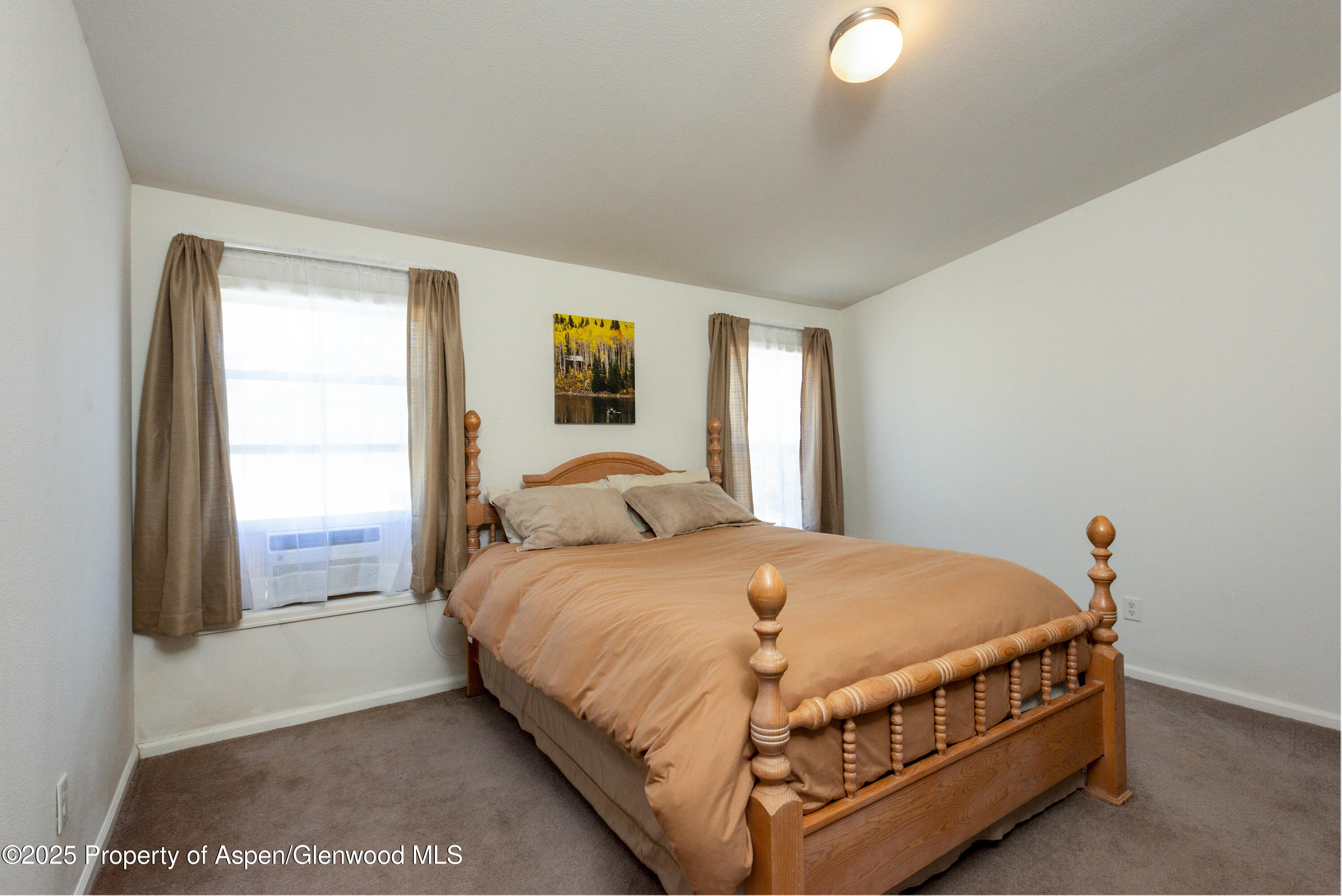 114 Rusty Spur Trail Rifle, CO 81650 - Photo 21 of 47 a bed sitting in a bedroom next to a window