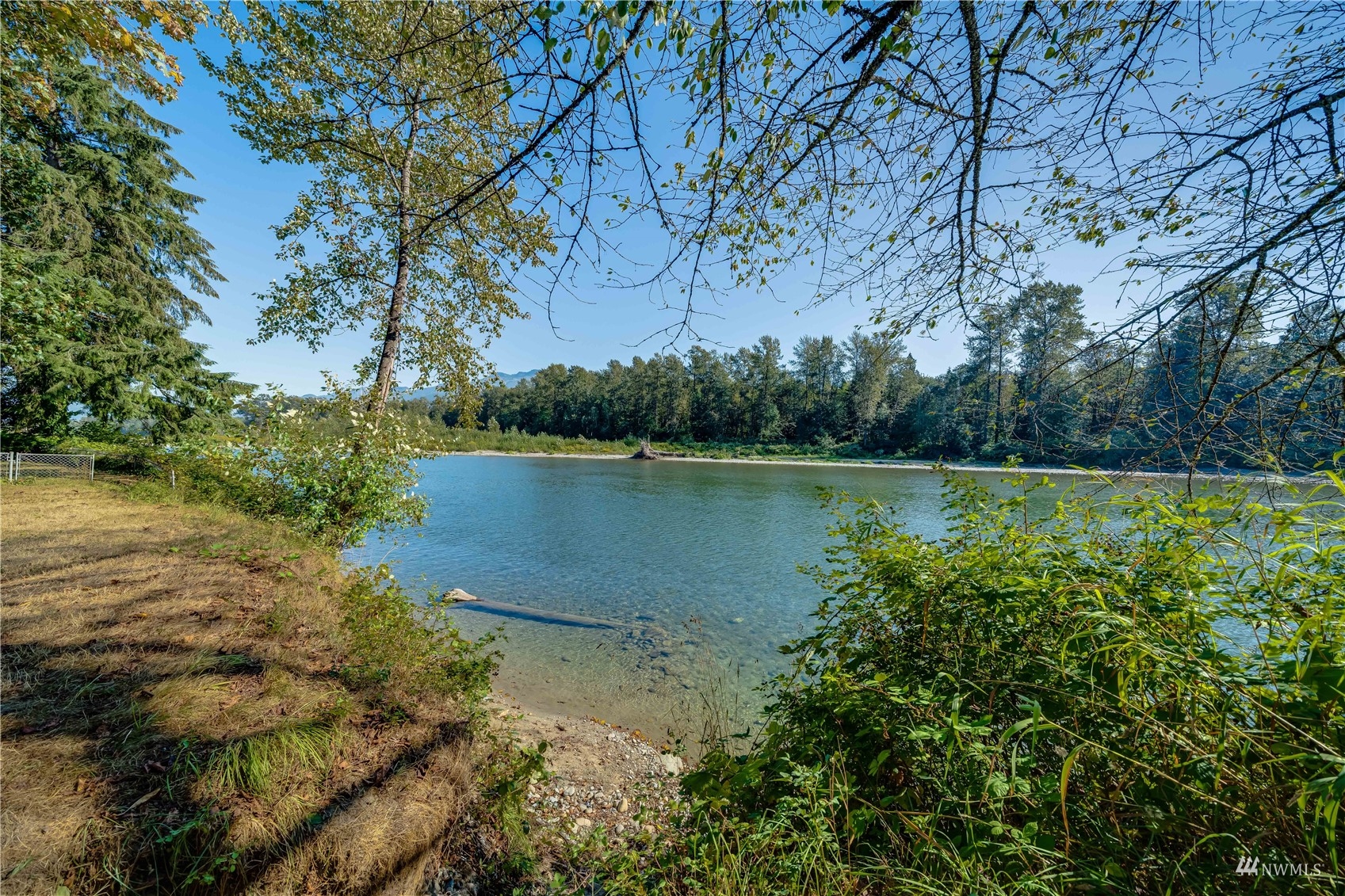 809 Dyer Road Sultan, WA 98294 - Photo 26 of 39 a view of a lake with a yard and large trees