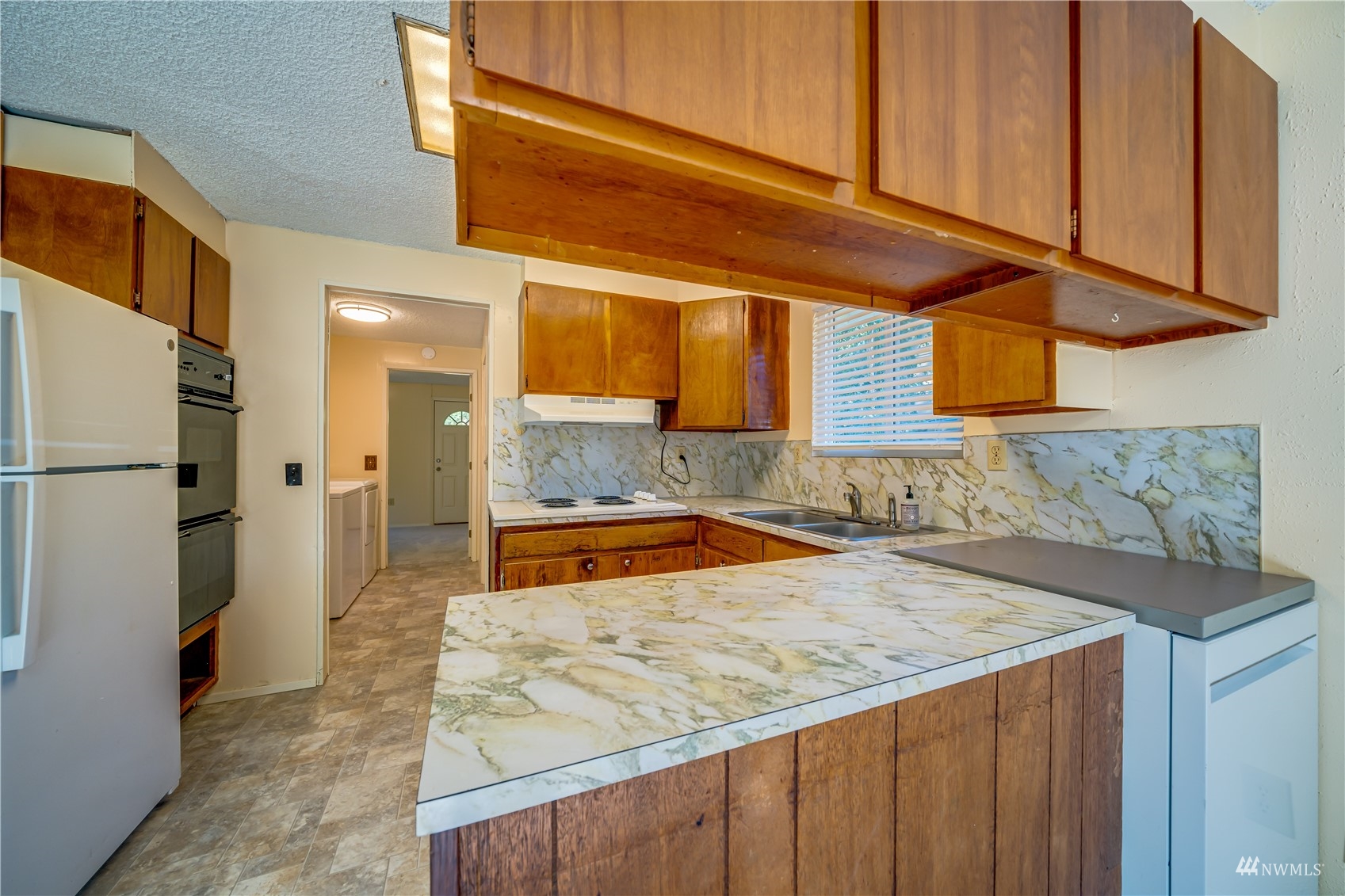 809 Dyer Road Sultan, WA 98294 - Photo 9 of 39 a kitchen with stainless steel appliances granite countertop a sink and a refrigerator