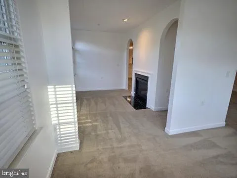 a view of empty room with a fireplace