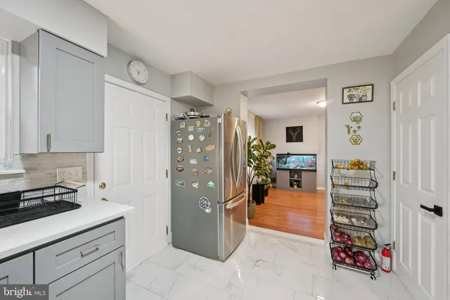 a kitchen with stainless steel appliances granite countertop a refrigerator stove and sink