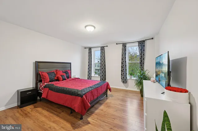 a bedroom with a bed and a potted plant