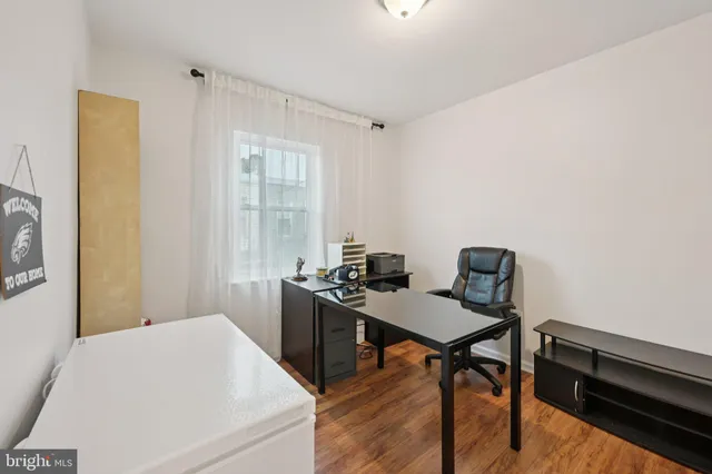 a view of bedroom with furniture and wooden floor