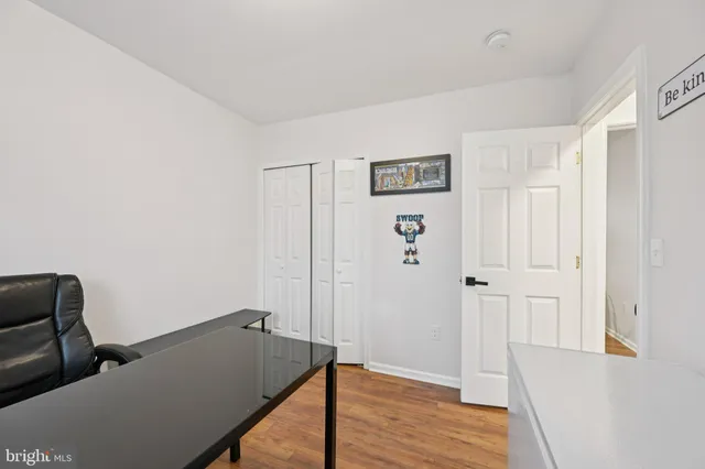 a room with lots of books and a large window