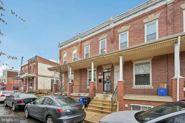 a front view of a building with parking space