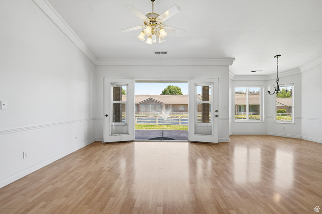 805 South River Road, Unit 70 St. George, UT 84790 - Photo 7 of 38 Expansive room with wood-finish flooring, crown molding, and wainscoting
