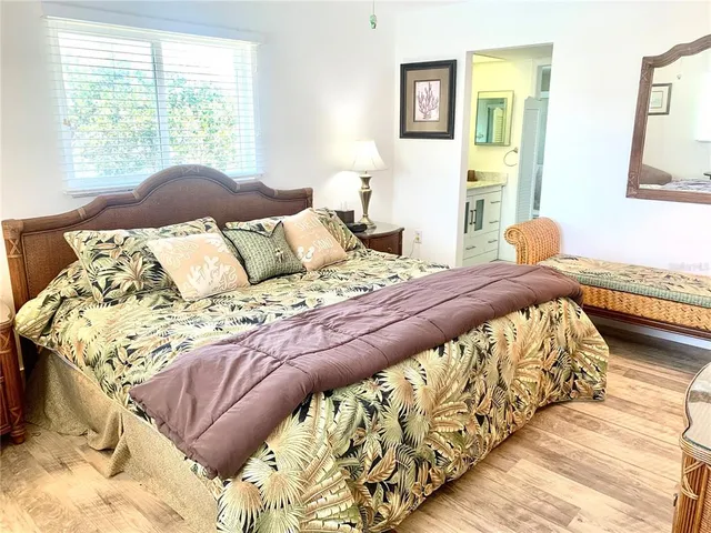 a view of a room with wooden floor and a rug