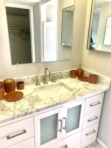 a kitchen with kitchen island granite countertop a stove top oven microwave and cabinets