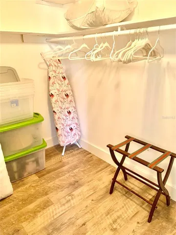 a kitchen with granite countertop a refrigerator a stove and white cabinets