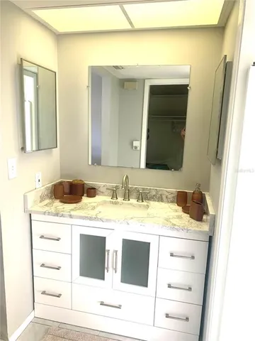 a view of bathroom with sink and mirror