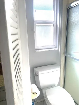 a kitchen with granite countertop white cabinets and stainless steel appliances