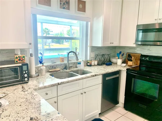 a kitchen with a sink and a stove