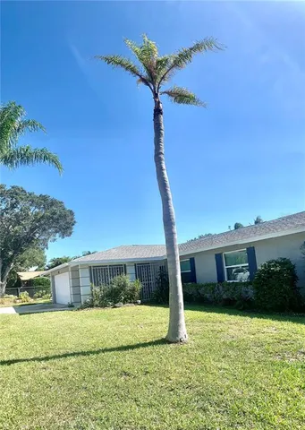 a view of a house with a backyard