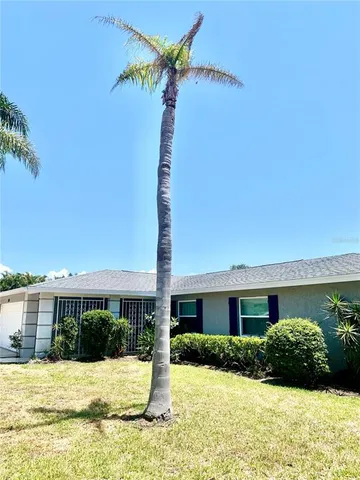 a bedroom with a bed and glass window