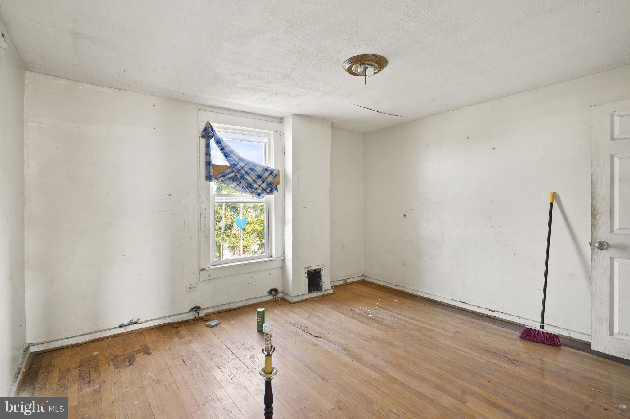 2121 Division Street Baltimore, MD 21217 - Photo 12 of 18 an empty room with wooden floor and windows