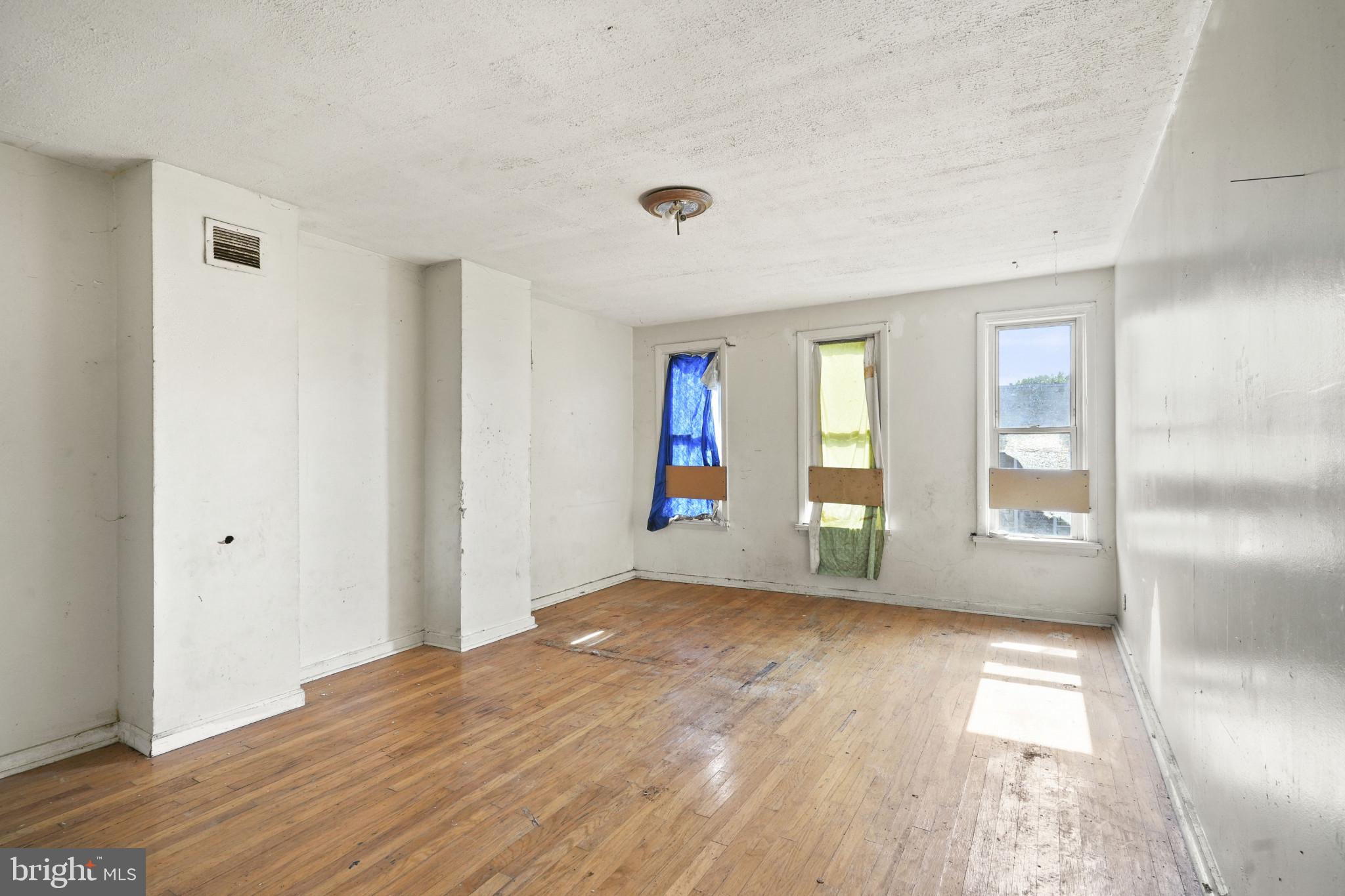 2121 Division Street Baltimore, MD 21217 - Photo 13 of 18 wooden floor in an empty room with a window